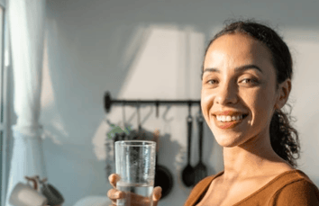 woman hydrating with water