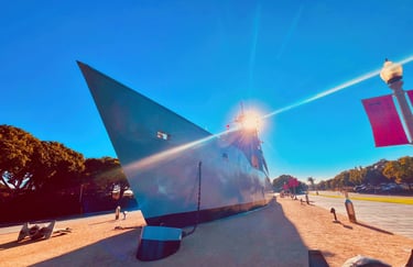 The USS Recruit landlocked ship model at Liberty Station in San Diego under a bright blue sky.