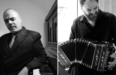 a man in a suit and tie playing the accordion