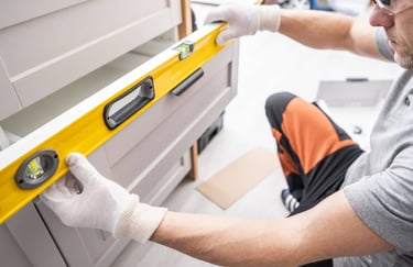 Cabinet installer leveling drawers and adjusting.