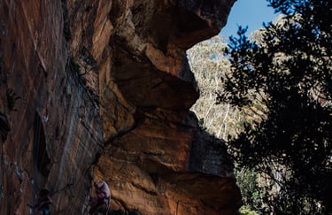 a man climbing a cliff face down a cliff