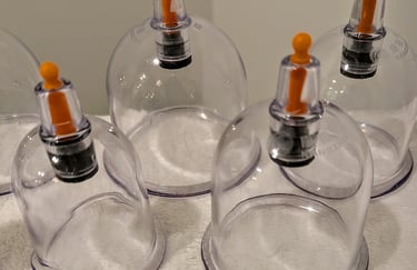 A set of clear plastic massage suction cups for professional cupping therapy and muscle recovery.