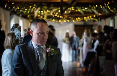 Groom waiting for his bride to walk up the aisle