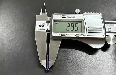 Digital caliper measuring a purple titanium screw showing a 2.95 mm reading on the LCD display | Rui