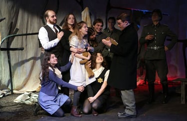 Ensemble during the "Red Cross Visit" scene