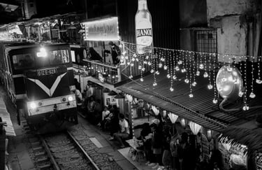 Hanoi Train Street black and white night photography train passing narrow street