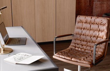 An image of a desk and office chair shown in rendered view on the computer in Blander.