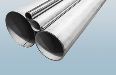 Industrial round stainless steel pipes and metal tubing in various diameters for construction.