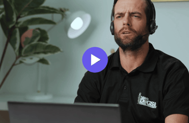 man with a headset working on a laptop