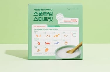 a box of rice pudding with a wooden spoon and a wooden spoon