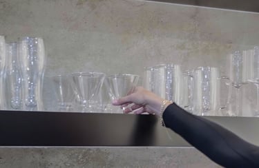 a woman is holding a glass of wine