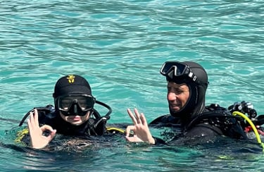 two people in scuba gear in the water