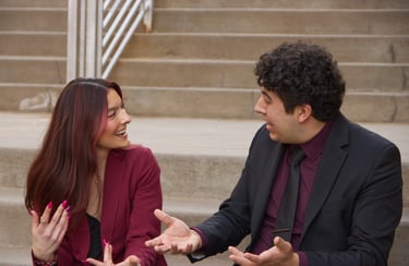 Quesada-Stoner and Gregg sitting to next to each other on stairs chatting excitedly