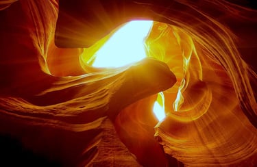 Flagstaff/Page Travel - Light streams down thru the wave like patterns of Antelope Canyon