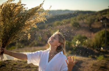 a woman holding a bunch of flowers in her hands