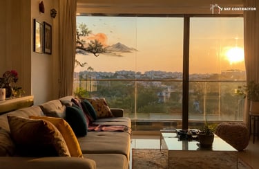 Modern living room interior with a cozy sofa and a panoramic sunset view over the city skyline.