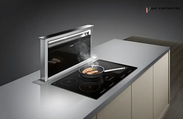 Modern induction cooktop with a sleek pop-up downdraft extractor fan venting steam from a frying pan.