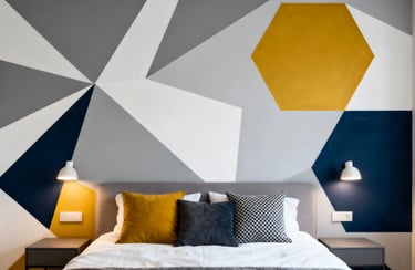 Modern bedroom featuring a geometric accent wall with grey, navy, and yellow triangular patterns.