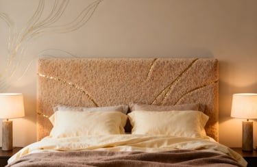 Modern bedroom with a luxury faux fur headboard featuring gold accents and warm bedside lamps.