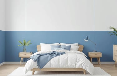 Modern bedroom with blue and white walls, featuring a wooden bed frame and white bedding.
