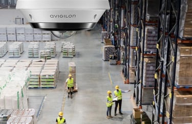 Warehouse equipped with AI-surveillance cameras monitoring inventory and employee activity.