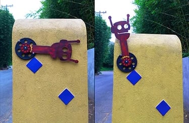 Red robot-shaped head used as a flag on a mailbox, shown in both up and down positions.