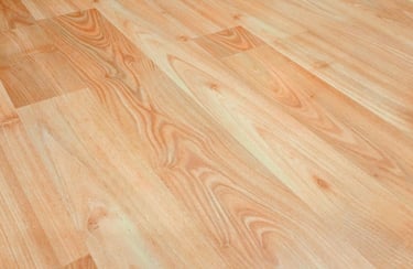 Light brown oak laminate flooring with realistic wood grain texture for home interior design.
