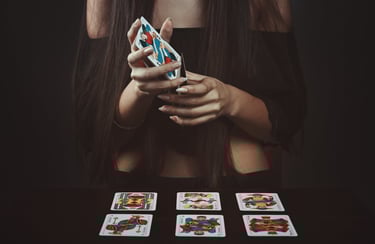 woman holding tarot cards during a tarot reading