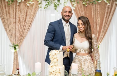 candid photo asian bride and groom cutting cake both happy and smiling 