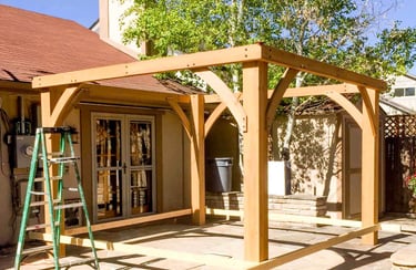 Building the heavy wood frame for a brand-new backyard pergola in Golden, Colorado.