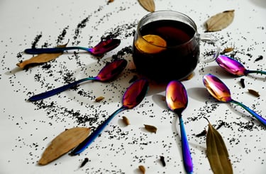 a cup of tea with spoons and spoons on a table