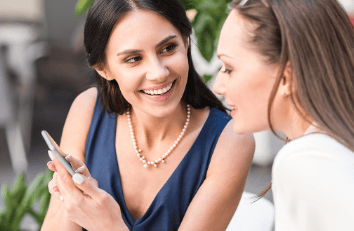 two women are sitting at a table
