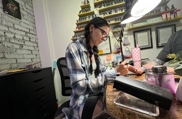 Alex doing nail art on acrylic nails in her salon booth in downtown Missoula