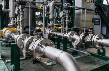 Industrial stainless steel piping and ball valves in a chemical processing plant facility.
