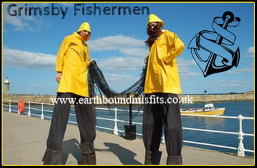 Two Grimsby Fishermen entertainers on stilts wearing yellow raincoats and holding a fishing net.