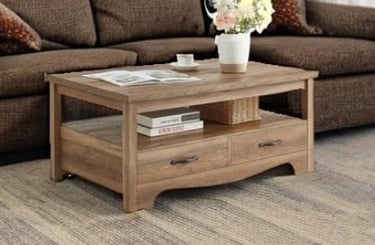 Rustic light oak wood coffee table with storage drawers and a lower shelf in a living room.