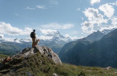 a person standing on a mountain top with a backpack