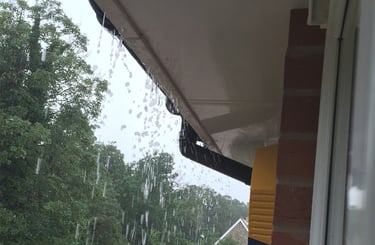 Rain water over spilling a compromised gutter