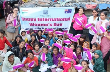 Group of girls and a few women holding up Hanaru's sanitary napkins