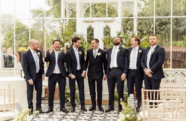 Groom with groomsmen laughing 