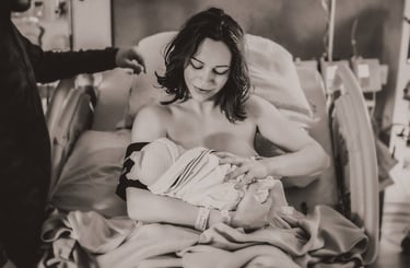 Mama cradling her newborn baby in a hospital bed in Grand Rapids, MN.