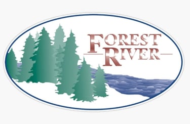 Forest River RV brand logo featuring evergreen trees and a flowing river in an oval frame.