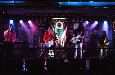 The five members of Hywater playing their instruments on stage