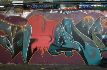 Graffiti calligraphy on urban surface — layered letters street writing Kende