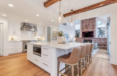 a kitchen with a large island and a fireplace