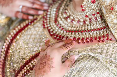 close up photo of asian bride's traditional gold dress and traditional jewellery 