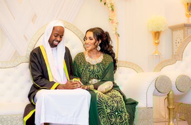 Somalian bride and groom laughing and smiling together while holding hands, in traditional outfits, light and airy photo