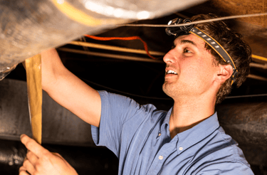 Jayden Kelly doing maintenance work in a crawlspace