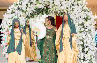 Somalian bride walking into venue with bridesmaids, all in vibrant traditional dresses, all happy and dancing  