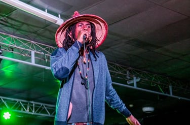a man in a hat and a hat on stage